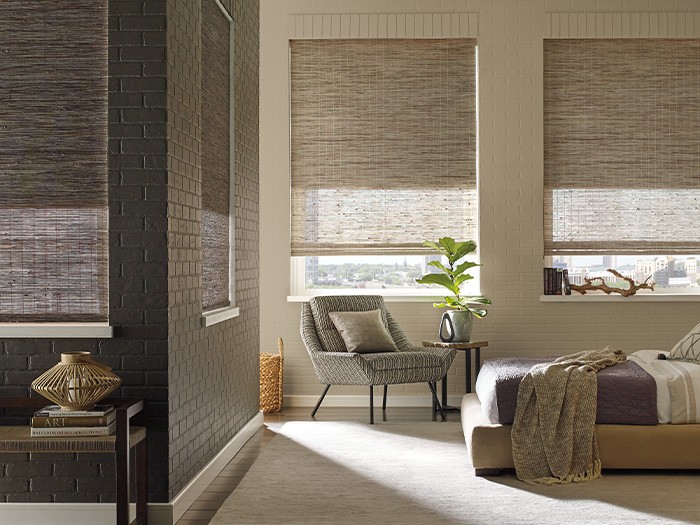 Living room featuring Provenance® Woven Wood window shades.